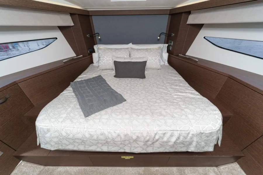 Bedroom interior with a bed and wooden walls on a boat.