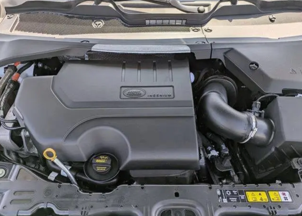 Car engine compartment with visible Ford logo