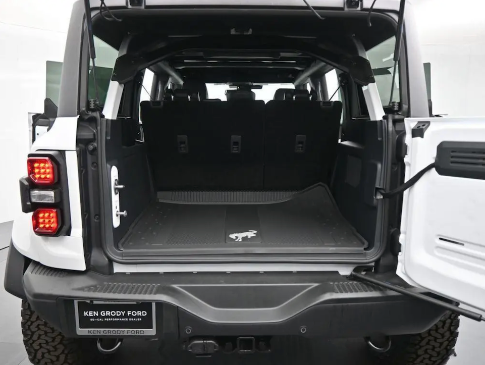Back of a white Ford vehicle with open cargo area