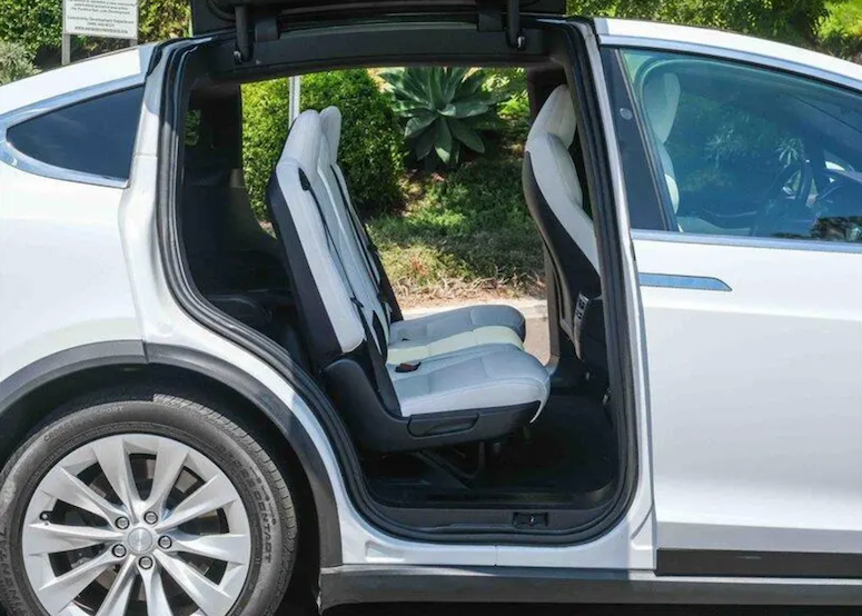 Car with open door showing a folded seat inside