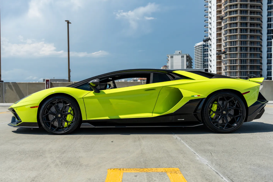 Lime green sports car on a city street with buildings in the background