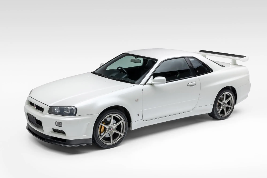 White sports car with a large rear wing on a white background