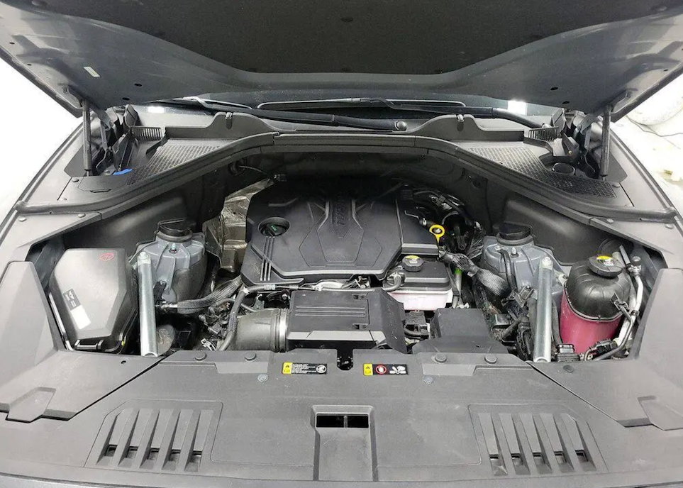 Car engine compartment with various components visible