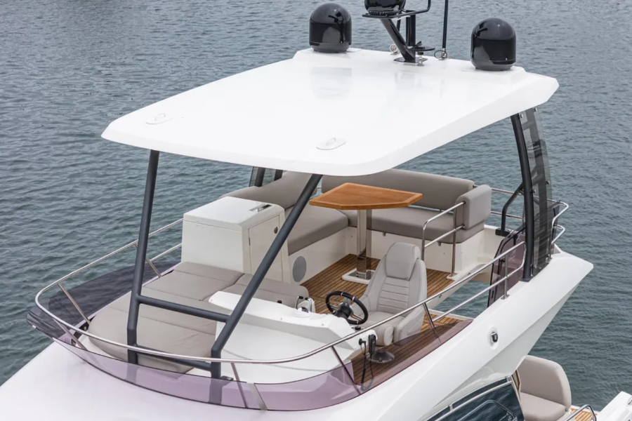 Yacht on water with a white canopy and interior.