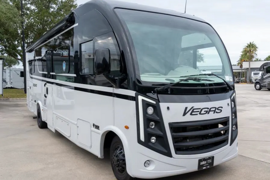 White bus with 'Vegas' branding on a concrete surface