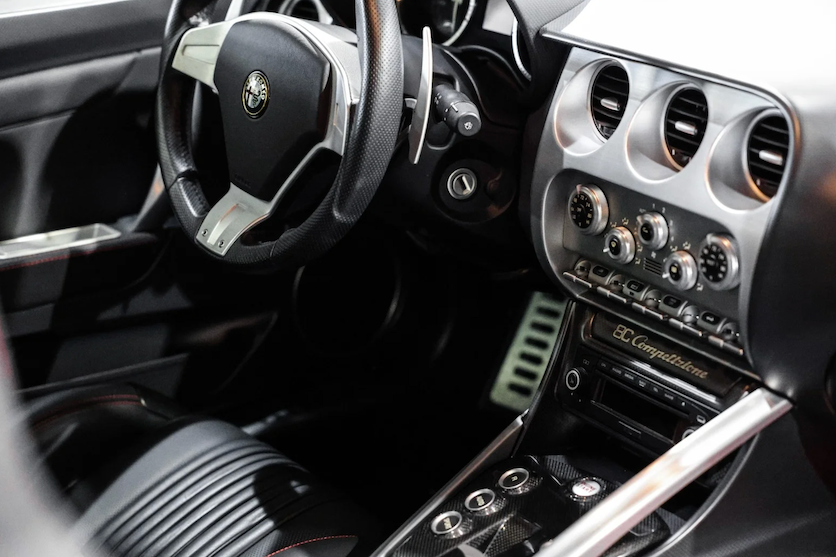 Close-up of a car's steering wheel and dashboard with 'Quicksilver' branding.