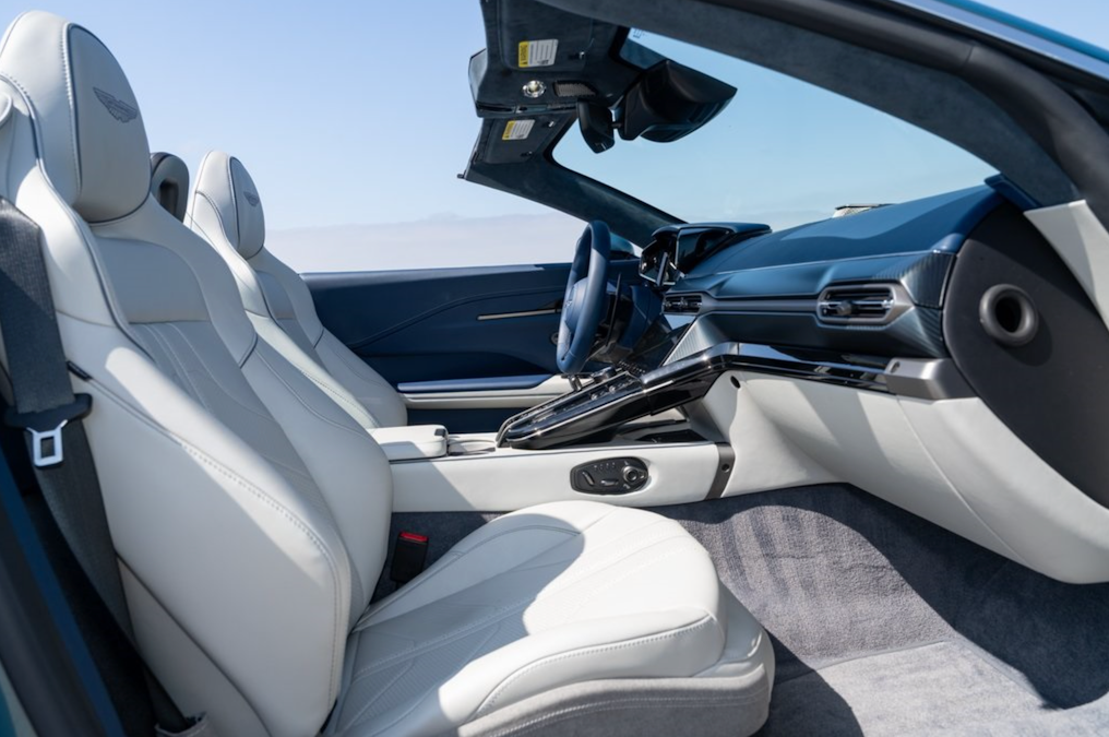 Car interior with white seats and a clear sky outside