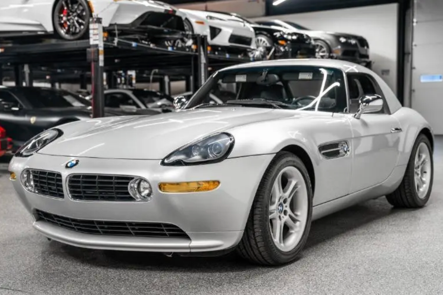 Silver BMW Z8 car in a showroom setting with other cars in the background