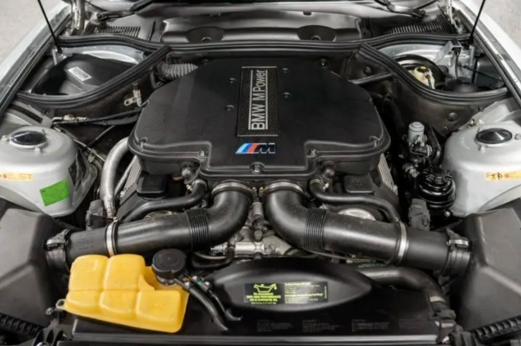 Car engine with BMW logo open hood