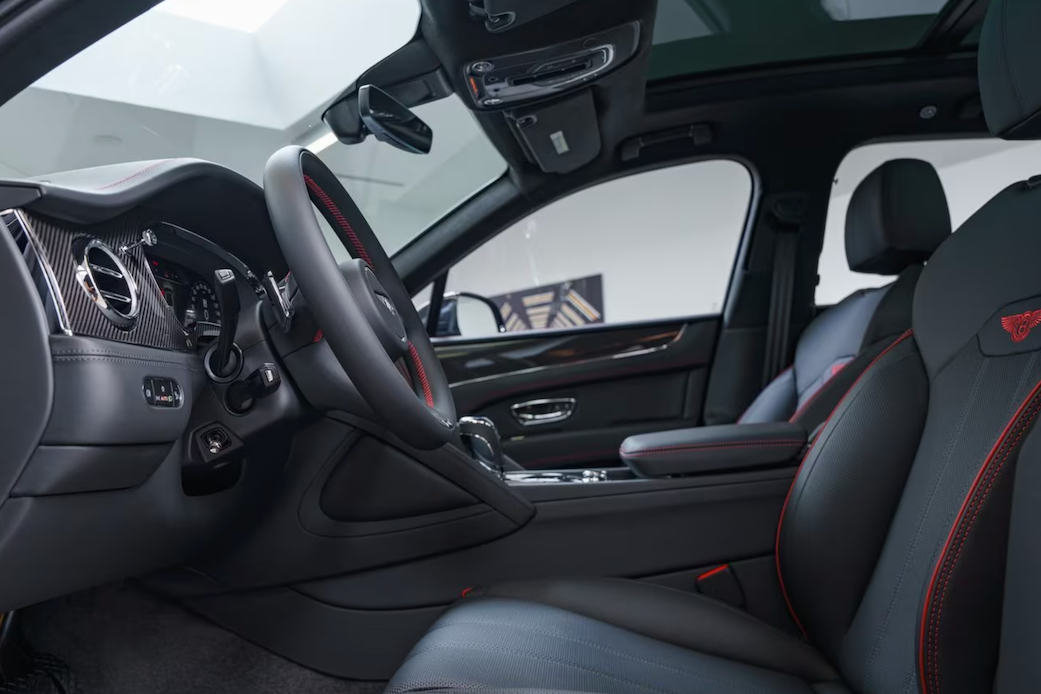 Car interior with steering wheel and dashboard in a showroom setting
