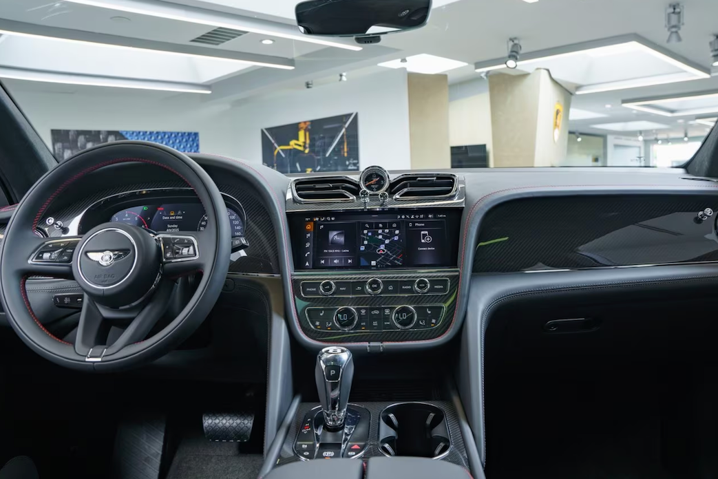 Car interior with steering wheel and dashboard in a showroom setting
