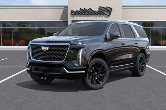 Cadillac SUV parked in front of a Cadillac dealership