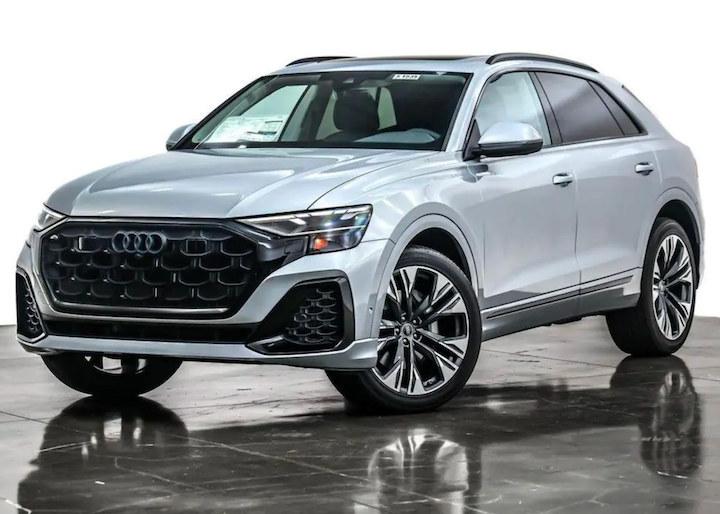 Silver Audi SUV on a reflective surface with a white background