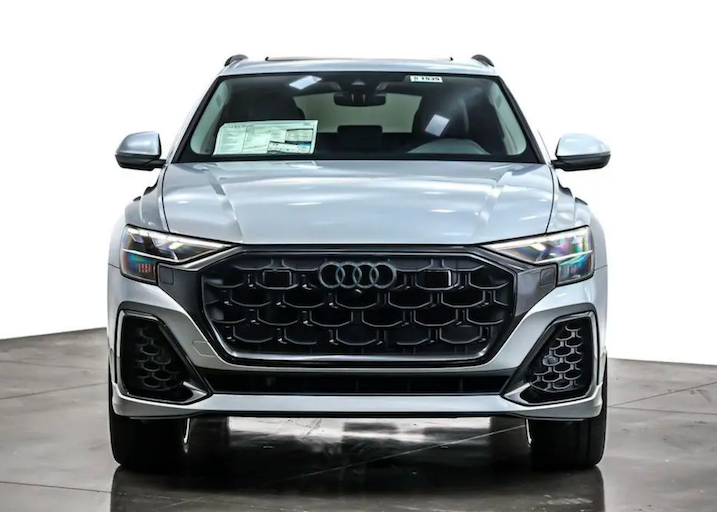 Front view of a silver Audi SUV in a showroom setting