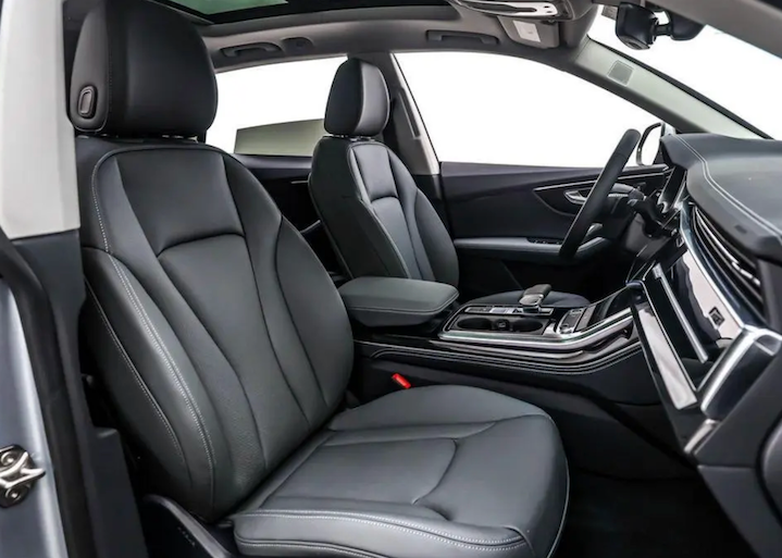 Car interior with gray leather seats and dashboard.