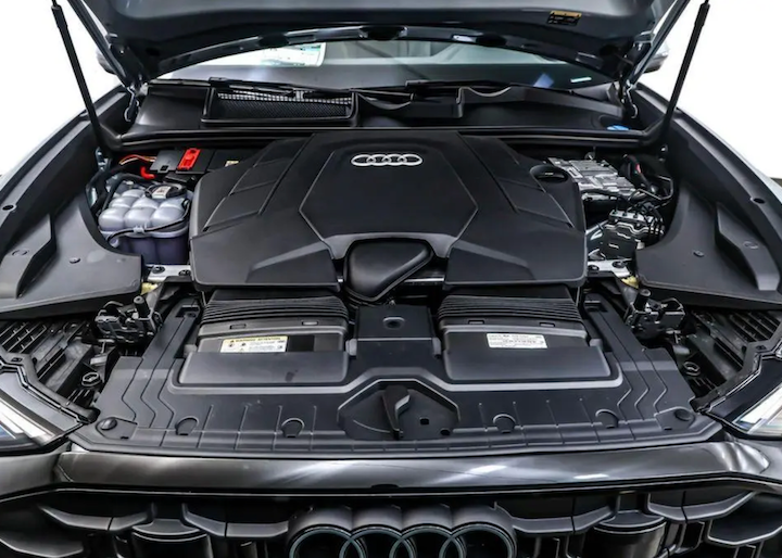 Audi car engine compartment with hood open on a white background
