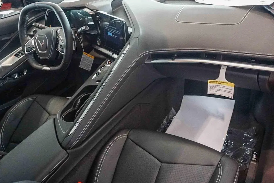 Car interior with dashboard, steering wheel, and seats.