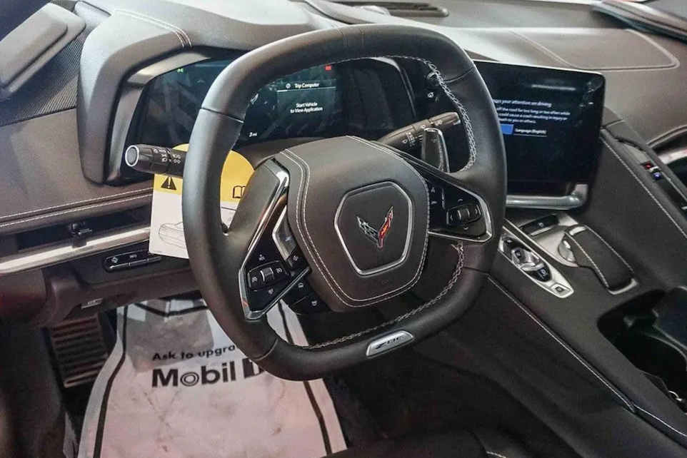 Steering wheel of a Corvette car with visible logo, dashboard, and ACDelco branding.