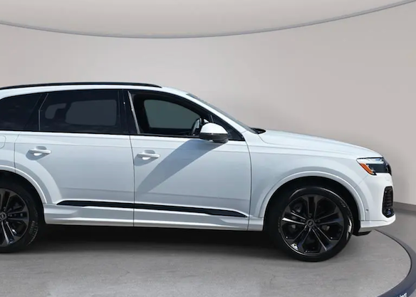 White SUV on a gray platform with a neutral background