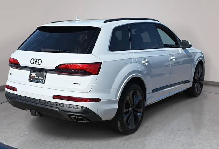 White Audi SUV parked indoors with a plain background