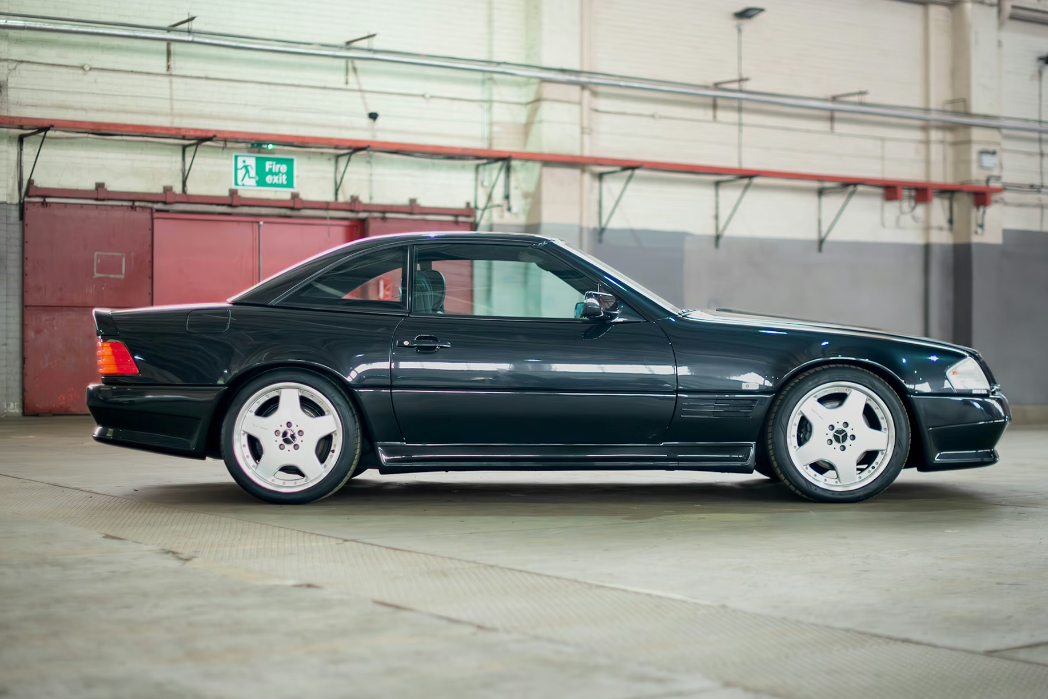 Black Mercedes-Benz SL-Class parked inside a warehouse.
