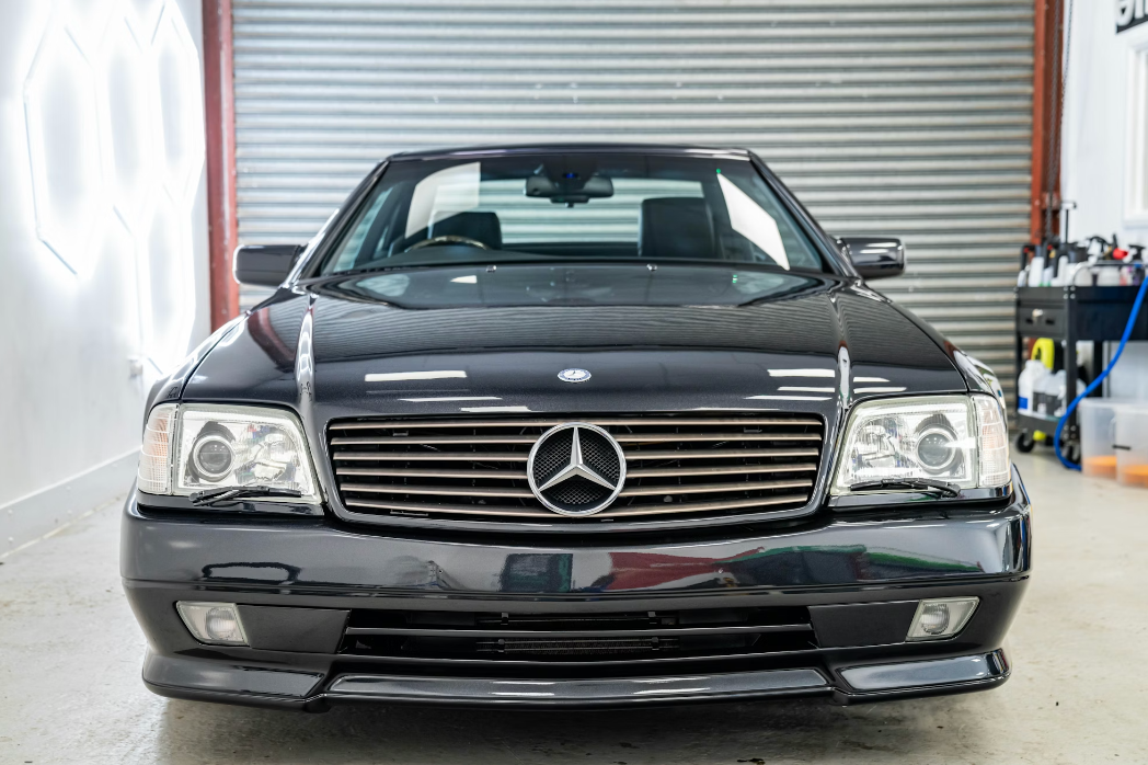 Black Mercedes-Benz car parked inside a garage.