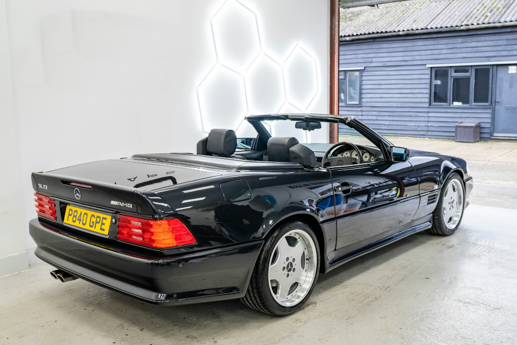 Black Mercedes-Benz SL-Class convertible in a showroom setting