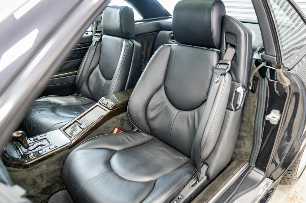 Close-up of a car's interior with gray leather seats.