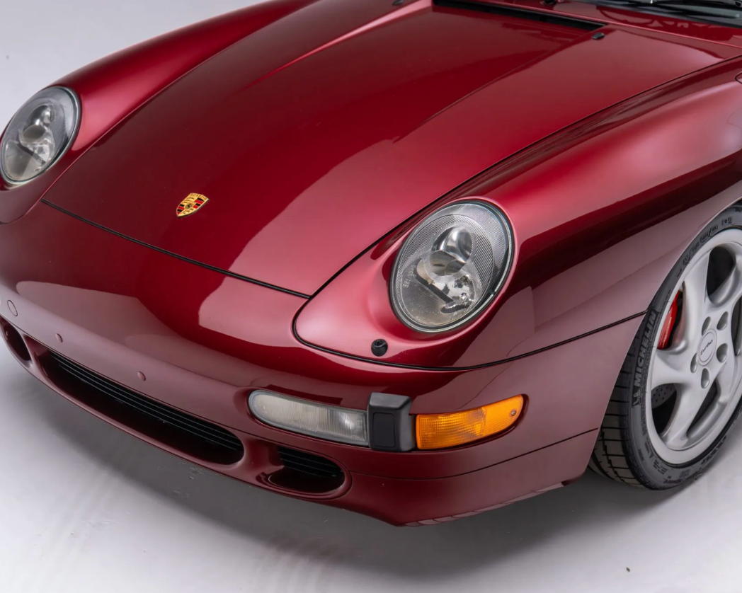 Red Porsche car on a white background