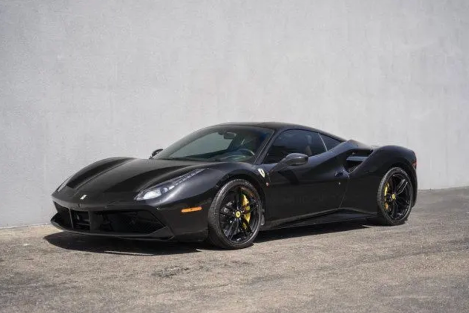 Black Ferrari sports car on a gray background