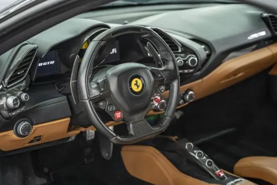 Steering wheel with Ferrari logo in a car interior