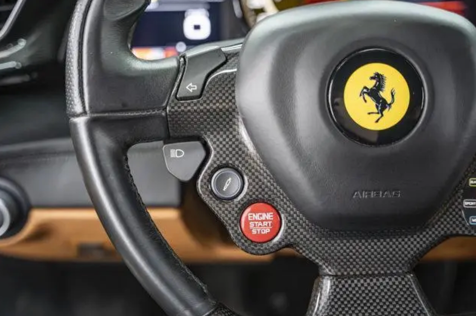 Steering wheel with Ferrari logo in a car interior