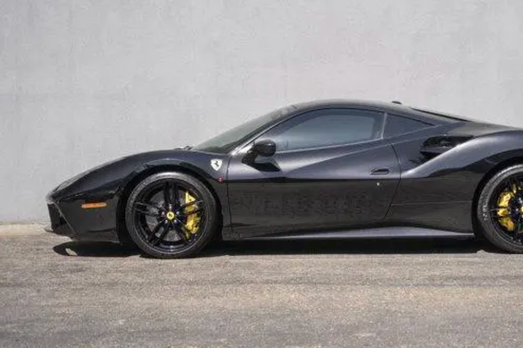 Black Ferrari sports car on a gray background
