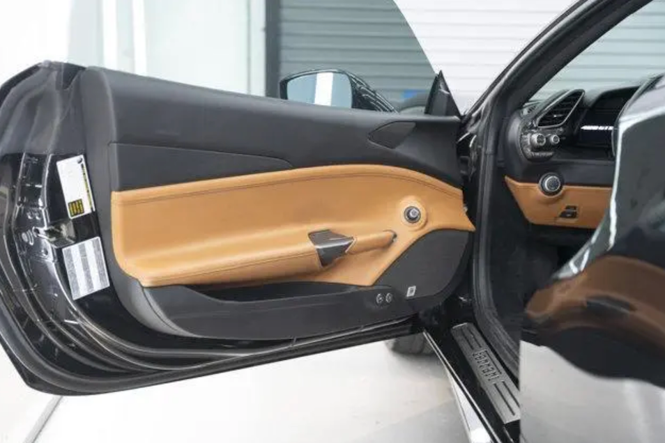 Car door open showing interior with beige and black design
