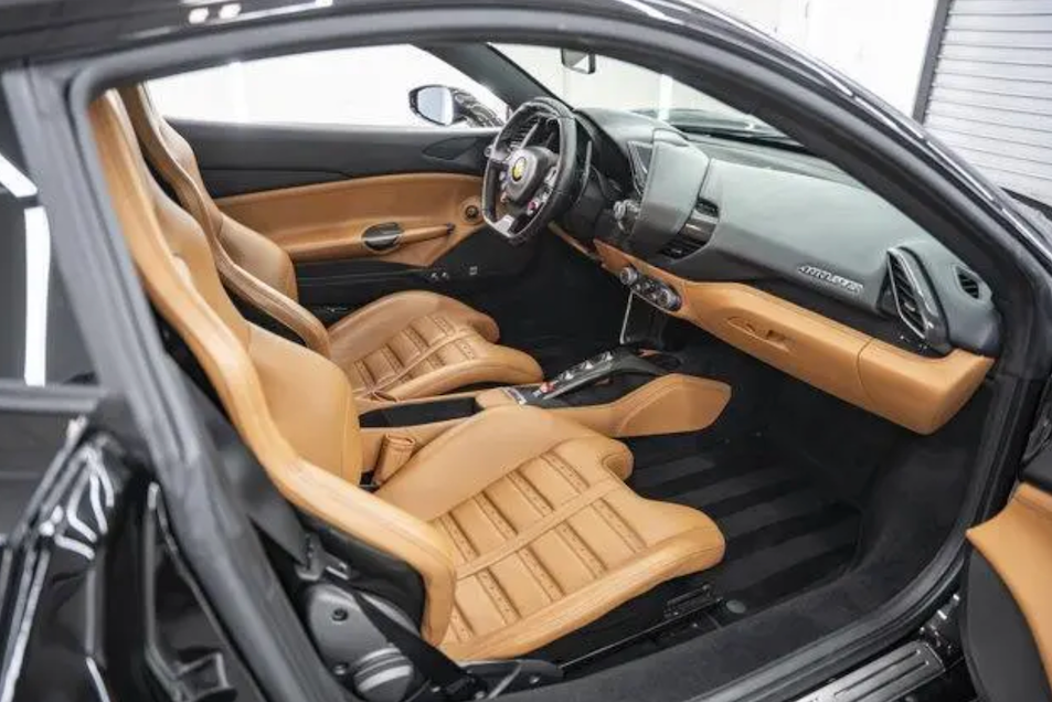 Car interior with tan leather seats and black dashboard