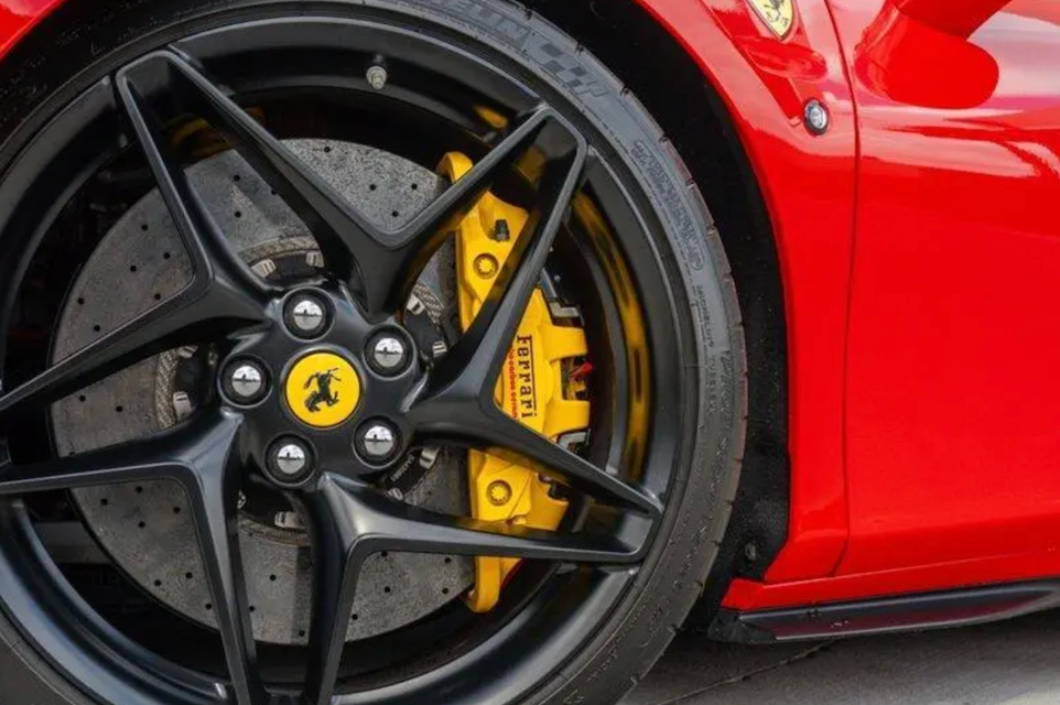 Close-up of a Ferrari wheel with red car body