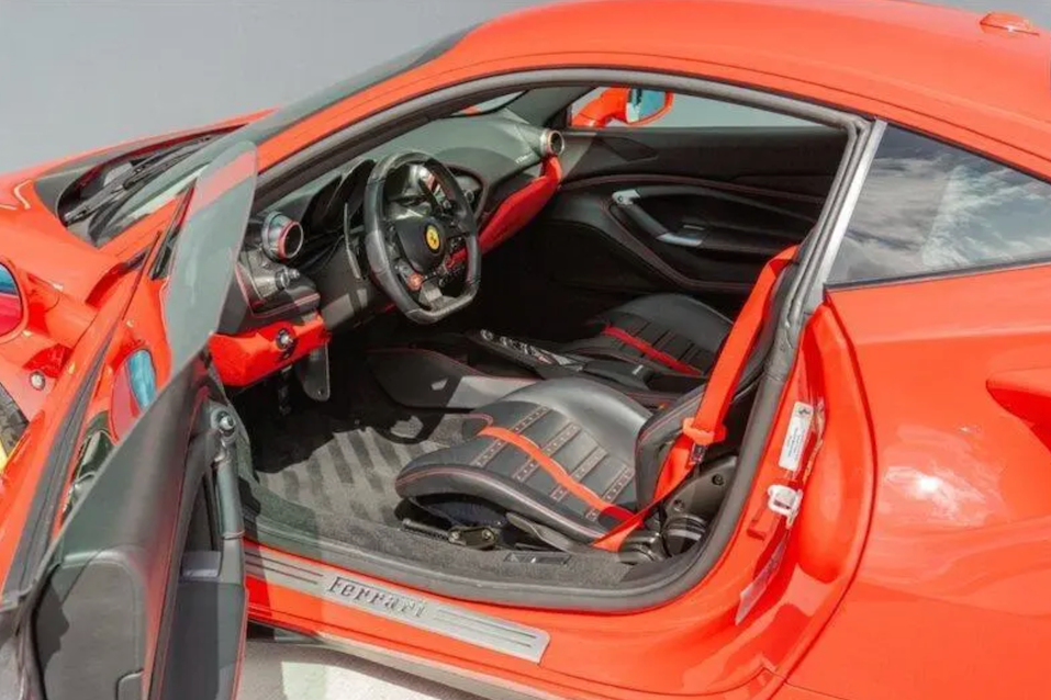 Close-up of the interior of a red sports car with open door