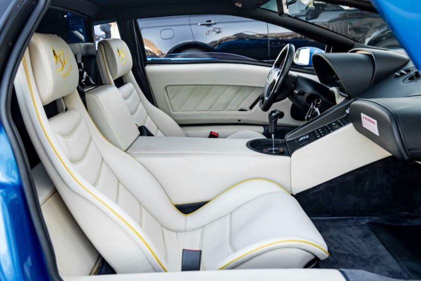 Car interior with white seats and blue exterior