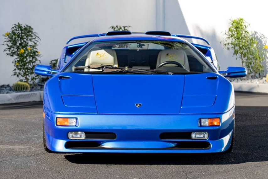 Blue sports car with a distinctive design on a road