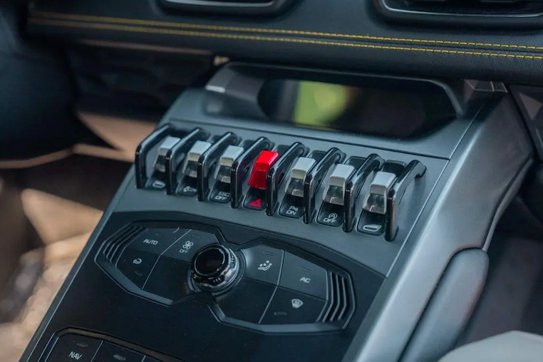 Close-up of a car's gear shift lever with control buttons