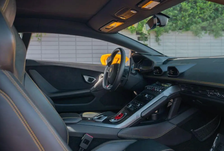 Car interior with a focus on the dashboard and steering wheel.