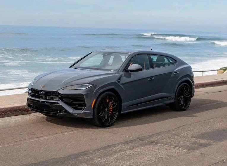 Gray Lamborghini SUV parked by the ocean