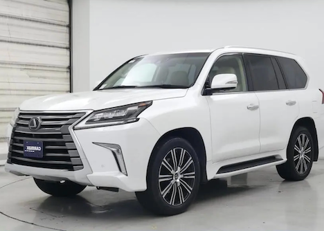 White Lexus SUV parked indoors with a white background