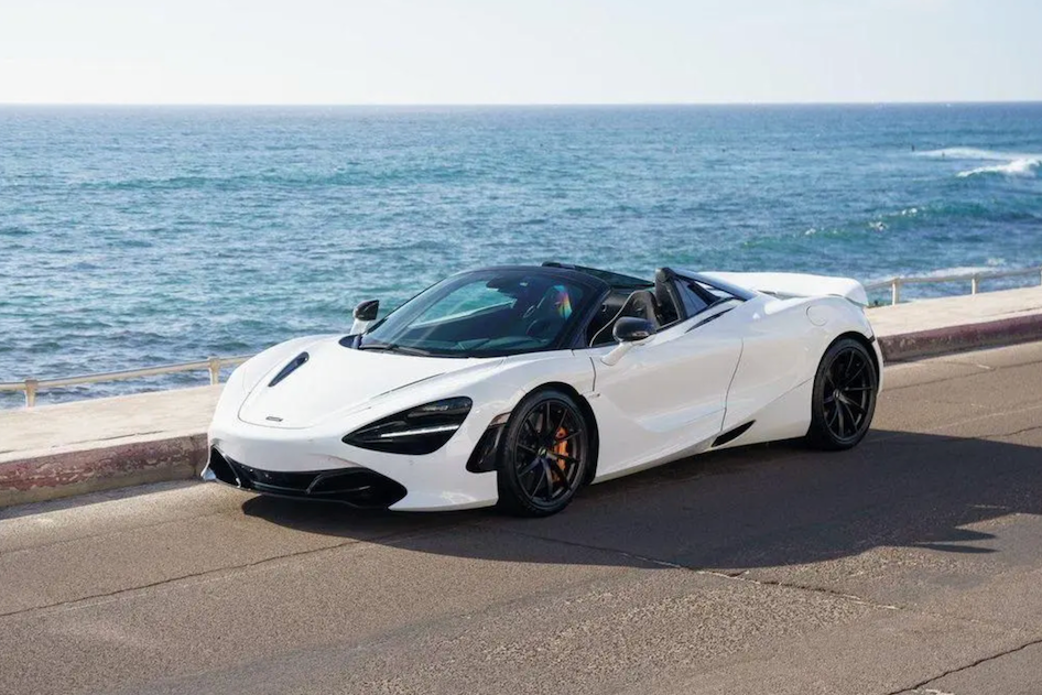 White sports car parked by the ocean