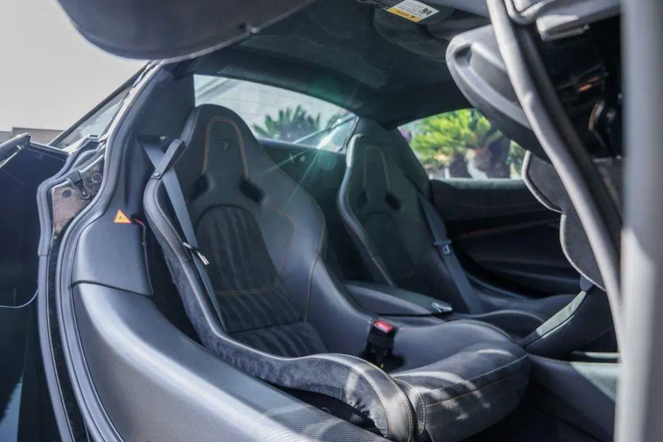 Close-up of the interior of a McLaren car with carbon fiber seats.