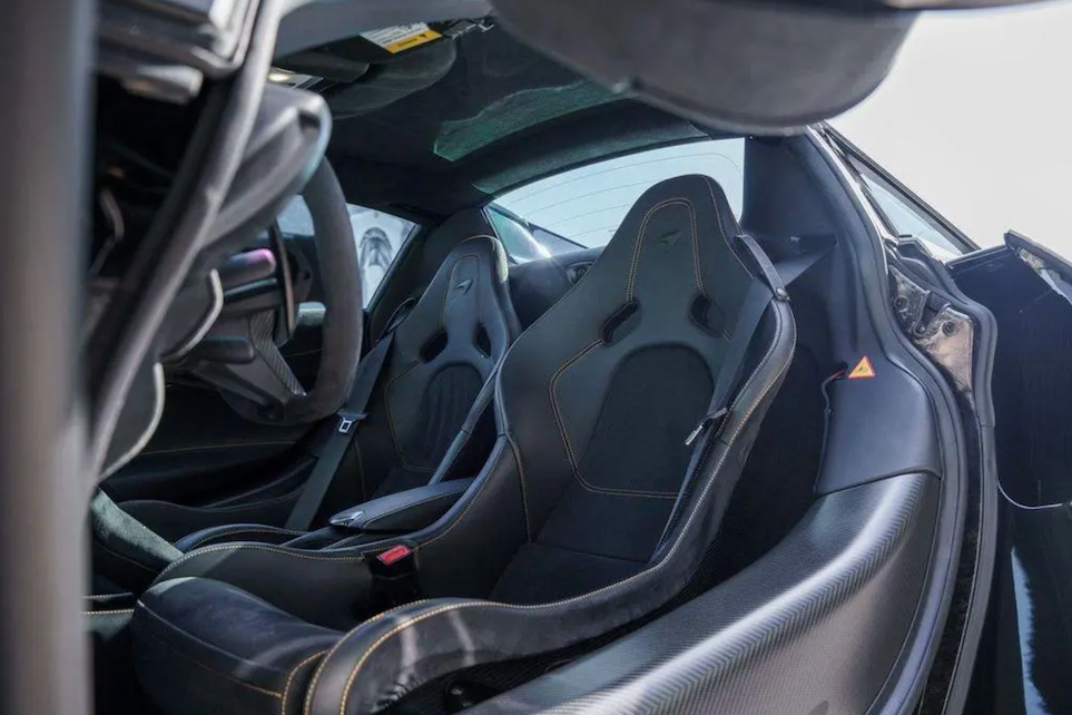 Close-up of a car's interior with racing seats and McLaren branding.