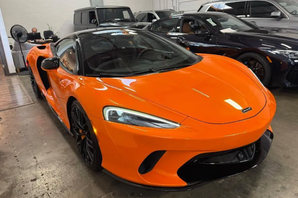 Orange sports car in a showroom setting