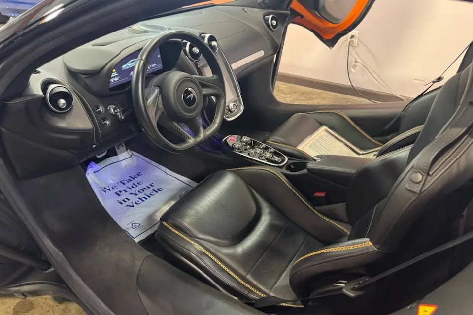 Car interior with steering wheel and dashboard view