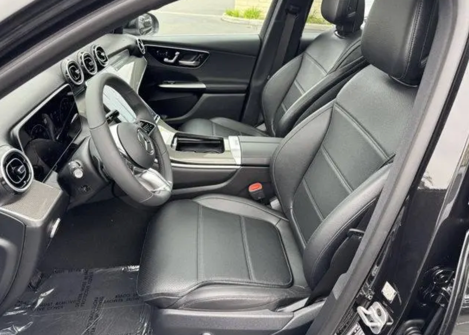 Car interior with gray leather seats and dashboard.
