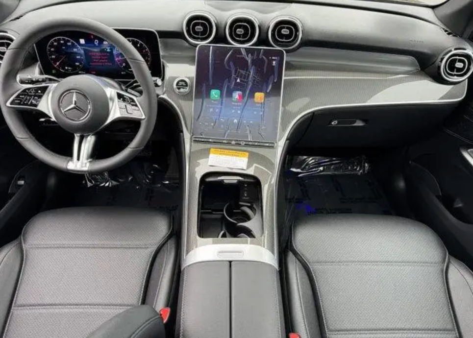 Car interior with steering wheel, dashboard, and center console.
